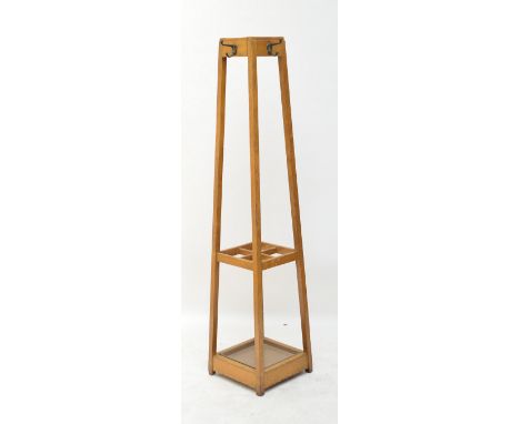 An Arts and Crafts hall stand of square tapering form with a hook to each side and with four division umbrella/stick stand wi