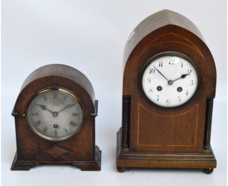 An Edwardian mahogany and inlaid lancet shaped eight day mantel clock, the circular enamel dial set with Arabic numerals, the