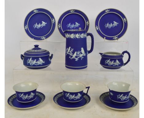 A Wedgwood and Caperns Ltd blue dip jasperware tea service comprising three trios (two cups af), a cream jug, a twin handled 