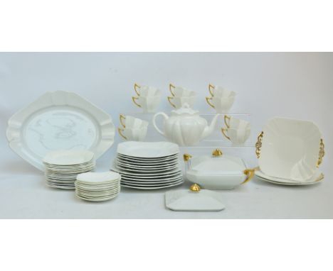 A Shelley dinner and tea ware of square form with canted corners comprising ten trios, six spare larger saucers, two sandwich