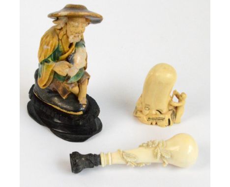 A Japanese Meiji period carved ivory netsuke, height 5cm, a carved ivory seal with white metal cap, length 8.25cm, and a smal