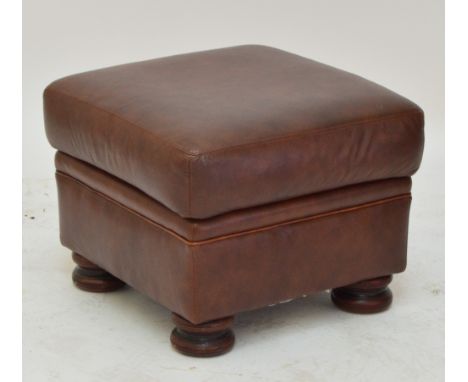 A brown leather pouffe