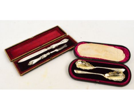 A cased pair of Victorian hallmarked silver and foliate engraved fruit serving spoons, Atkin Bros, Sheffield 1894, and a case