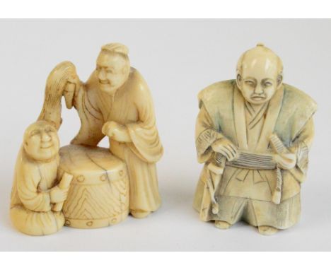 A Japanese Meiji period carved ivory netsuke of two figures beside a barrel drum, height 5.25cm, and a further netsuke of a J