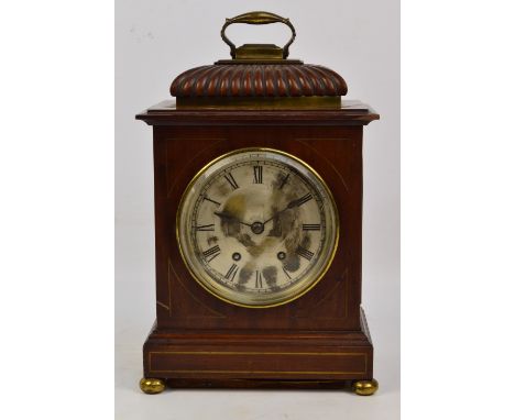 An early 19th century mahogany eight day mantel clock with brass mounts and feet, and gadrooned canopy, the brass dial set wi