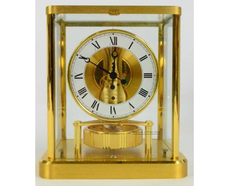 JAEGER-LECOULTRE; a brass Atmos clock with Roman numerals to the chapter ring and rounded rectangular base, unboxed, height 2