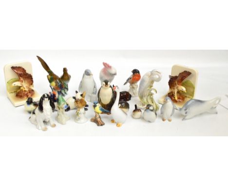A collection of decorative porcelain figures including a Royal Dux parrot, Goebel, etc.