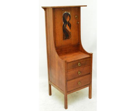 An Arts and Crafts oak side cabinet, the upper section with detailed inlaid panel to the cupboard door depicting a young maid