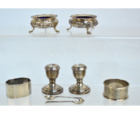 A pair of Victorian hallmarked silver open circular salts with cast decorated rims and embossed and engraved with foliate and