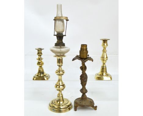 A brass candlestick with associated glass oil lamp upper section, height including funnel 43.5cm, a decorative brass candlest