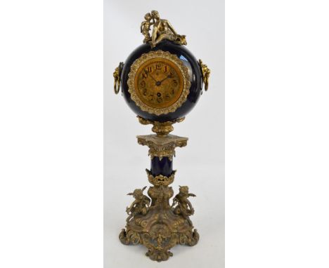 A decorative brass mounted mantel clock with drum upper section set with brass dial with Arabic numerals and Lenzkirch moveme