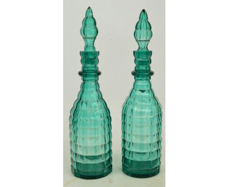A pair of 19th century green glass single ring neck panel sided decanters, height 35cm. CONDITION REPORT: Wear and small nibb