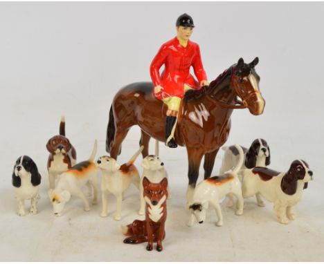 A Beswick hunting group comprising "Huntsman", model no.1501, four various models of fox hounds, three "Cocker Spaniel Horse 