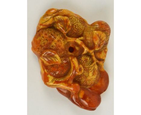A Japanese Meiji period amber netsuke carved with pineapple and branches, approx 5.5 x 4cm, 11.8g. CONDITION REPORT: Some tin