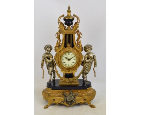 A large Italian reproduction French Empire style gilt metal mantel clock, the circular enamel dial set with Roman hour numera