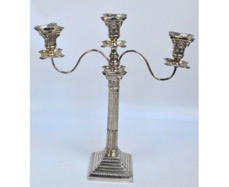 A George V hallmarked silver Corinthian column candlestick with stop fluted shaft and square stepped loaded base with beading