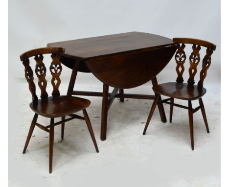 An Ercol dropleaf dining table raised on four outswept supports and a set of six Ercol dining chairs (5+1) (7).