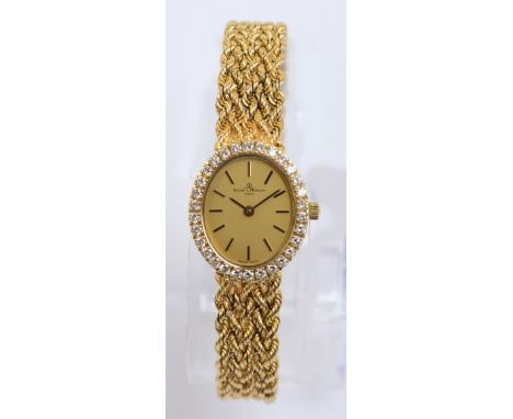 BUECHE-GIROD; a lady's 18ct yellow gold diamond set wristwatch, the circular dial set with black hour markers on a gold colou