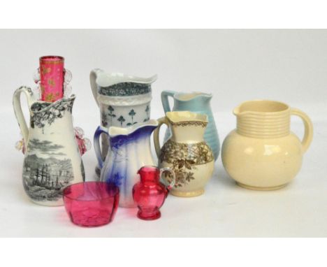 A small quantity of ceramic jugs including an example with a scene of Sebastopol, an Ironstone blue and white jug, a large gr