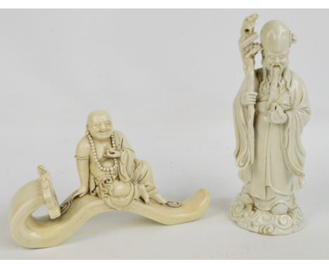 Two Chinese blanc de chine figures, one depicting a laughing Buddha seated on a ruyi sceptre, length 28cm, the other depictin