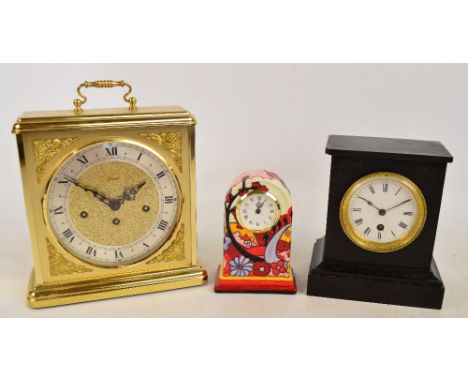 A late 19th century French black slate mantel clock, the white enamel dial set with Roman numerals, height 21cm, a decorative