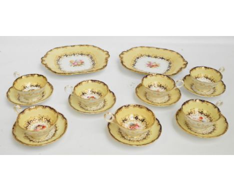 A mid 19th century Davenport part tea service with painted floral centres and gilt heightened cream and blue rims, comprising