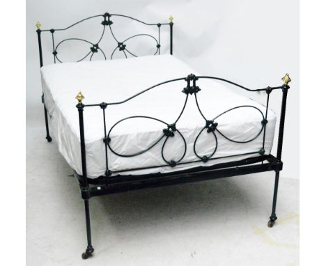 A Victorian iron and brass capped three quarter sized double bed, width 118cm. CONDITION REPORT: Chipping to paintwork throug