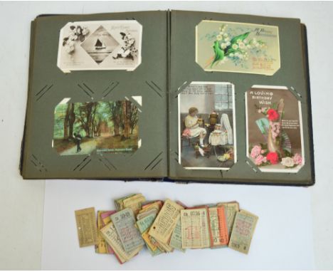 An early 20th century photograph album containing various portrait photographs and a collection of predominantly greetings po