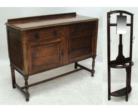 An early 20th century oak sideboard with two frieze drawers above two cupboard doors, on turned stretchered supports, width 1