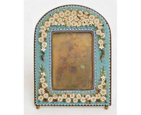 A late 19th century Italian micromosaic frame with arched top, decorated with numerous daisies on a light blue ground, 12 x 9