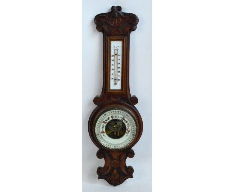 A 20th century walnut aneroid banjo barometer.