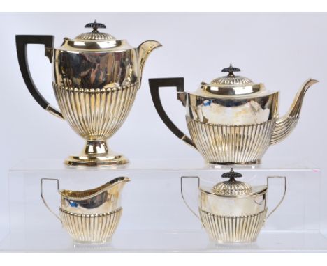 An Elizabeth II hallmarked silver four piece tea set comprising a teapot of oval form with gadrooned decoration to lower part