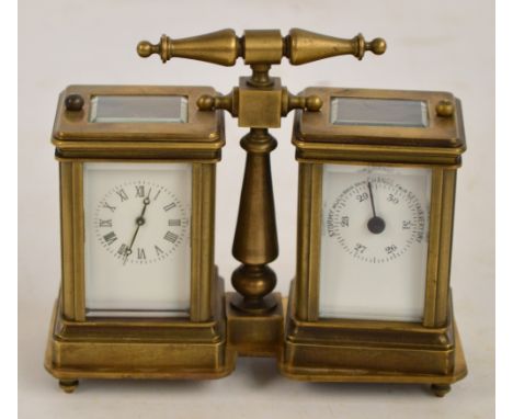 An early 20th century brass cased combination carriage clock and barometer, the central turned handle above twin white enamel