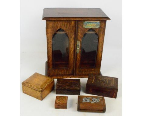 An early 20th century oak two door smoker's cabinet, and five small trinket boxes (6).