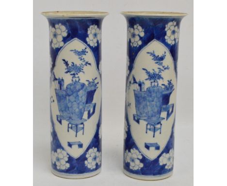 A pair of 19th century Chinese porcelain sleeve vases painted in underglaze blue with two opposing panels depicting a chrysan