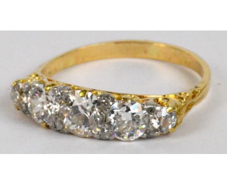 A yellow metal five stone graduated diamond ring in pierced scroll mount, diamond weight estimated 1.40cts, size M, approx 2.