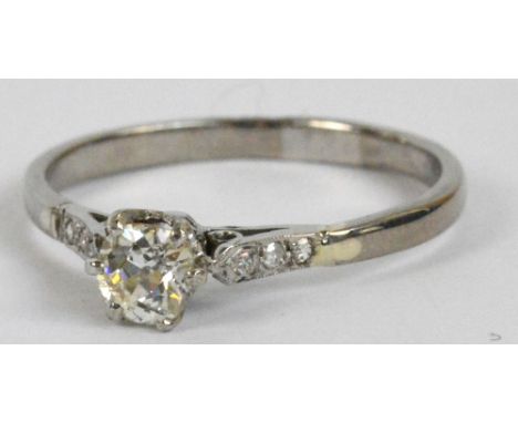 A white metal diamond ring, the central stone weighing approx 0.42cts with further tiny diamonds to the shoulders, size R/S, 