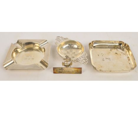 An Elizabeth II hallmarked silver tea strainer with twin pierced handles, makers initials HH, length 10.5cm, a rectangular as