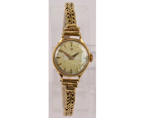 OMEGA; a 9ct yellow gold cased manual wind lady's wristwatch, the circular dial set with baton numerals, case and bracelet cl