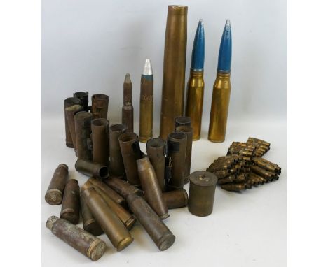 A quantity of brass shell cases, one dated 1944, some linked in belt form, two 30mm practice rounds and a trench art lighter