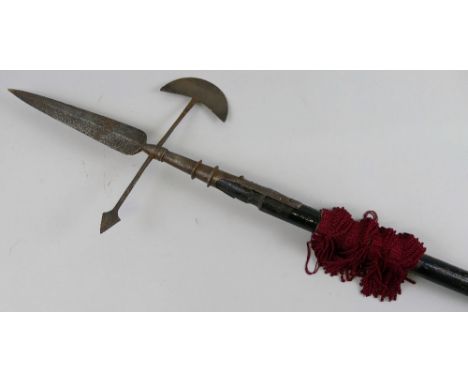 A steel halberd, the central spear with double headed axe cross-piece on long ebonised wooden shaft 245cm long