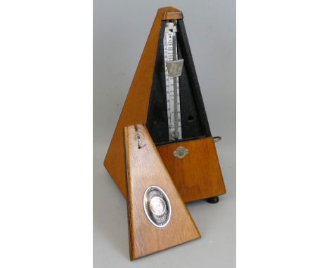 A Maelzel Germany clockwork metronome with typical pyramid shaped wooden case 23cm high
