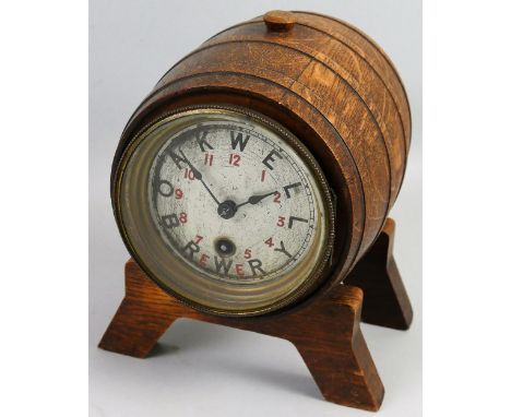 An oak advertising mantel clock for Oakwell Brewery in the form of a coopered barrel on two stands, one end containing an eig