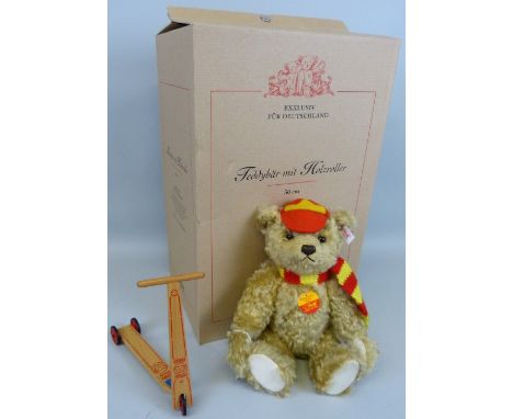 A Steiff limited edition teddy bear with scooter No.776/2000 30cm high boxed with outer packaging