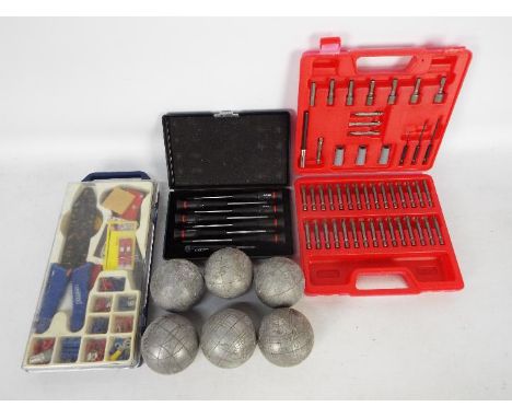 A small quantity of tools and a set of boules.