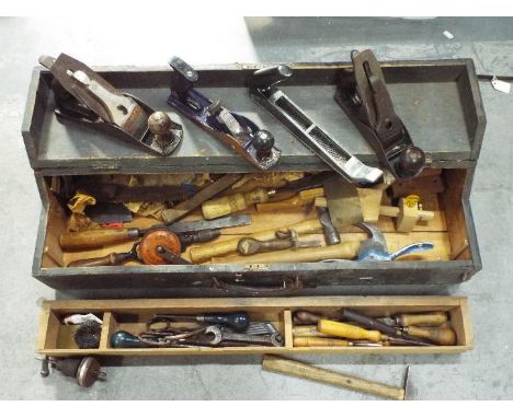 A vintage tool chest containing a quantity of vintage hand tools.