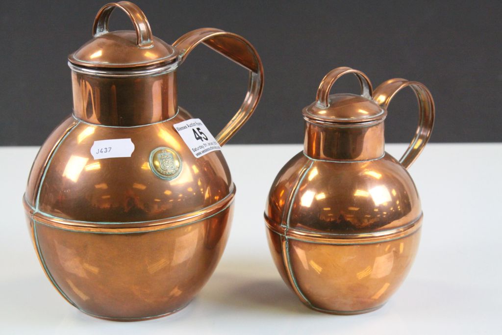 Two vintage Guernsey Copper Cream or Milk jugs with lids
