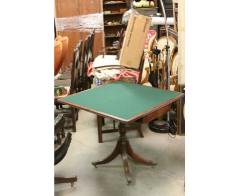 Reproduction Regency Mahogany Fold-Over Card Table with green baise playing surface and raised on single column with four spl