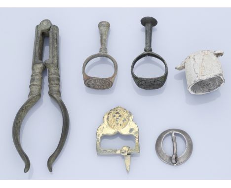 Tudor and Stuart, Assorted artefacts (6), including brass nutcrackers; seal ring and pipe tamper (2), one seal engraved with 