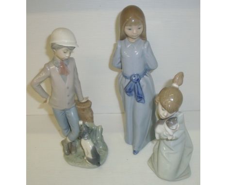 Two Nao figurines, one of girl in a blue dress & one of a boy with his dog and a Lladro figure of a young girl with a cat (A/